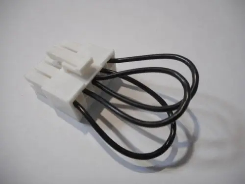 Weißer Stecker mit mehreren Klemmen und schwarzen Drähten, hergestellt von Remeha, geeignet für elektrische Verbindungen in verschiedenen Anwendungen.